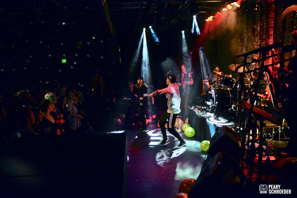 The Burroughs performing across the Moxi Theater stage