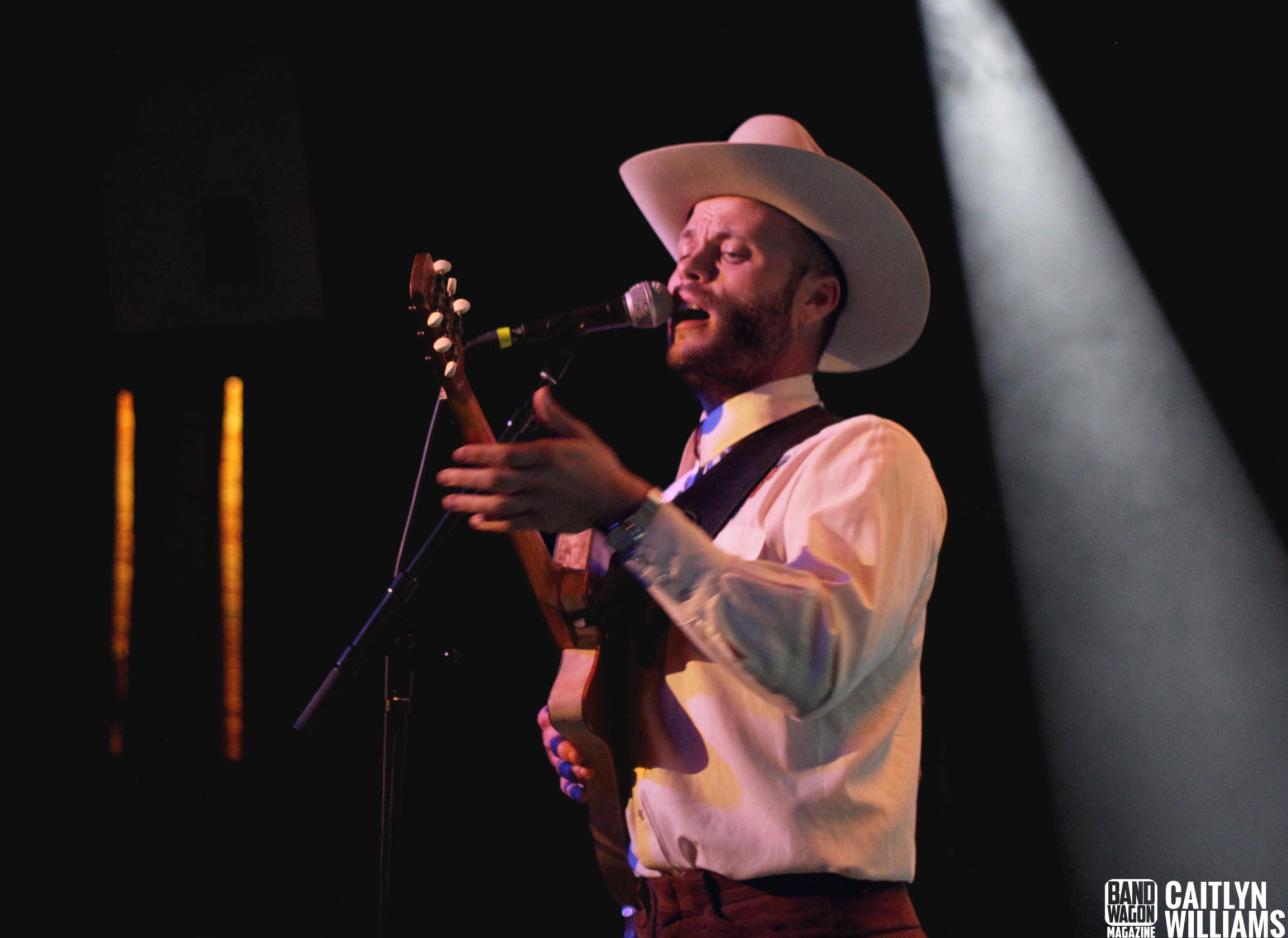 Charley Crockett performs under a spotlight at Moxi Theater on June 14, 2018